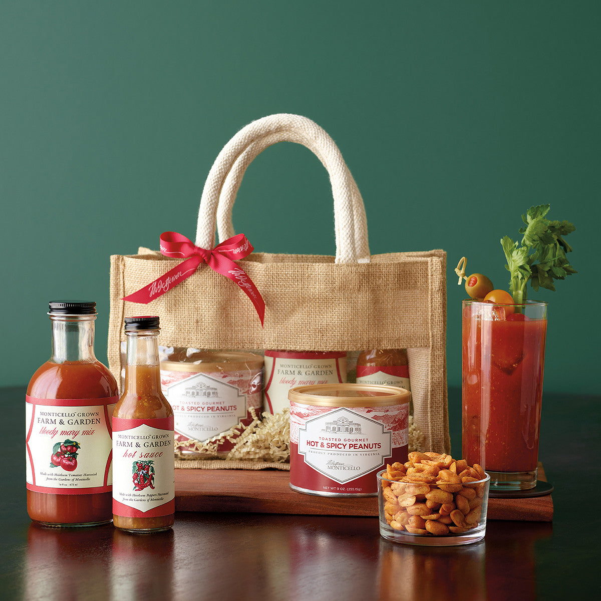 Burlap tote bag next to spicy peanuts, bloody Mary mix, and hot sauce.