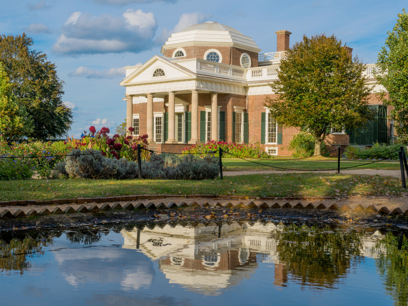 Monticello's West Front partially reflected in small nearby pond