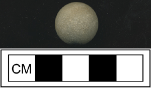 A clay marble excavated by archaeologists at Monticello photographed above a 5cm measurement card