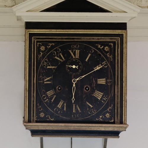 Image of the interior face of the Great Clock in Monticello's Entrance Hall