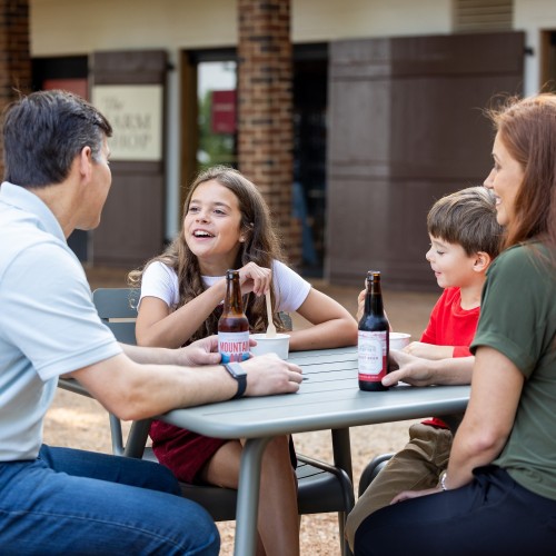 Guests enjoy drinks and ice cream at tables by the Farm Shop at Monticello