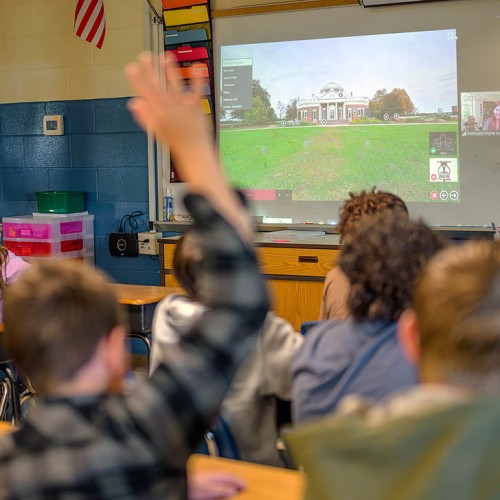 A student raises his hand during a guided virtual tour of Monticello