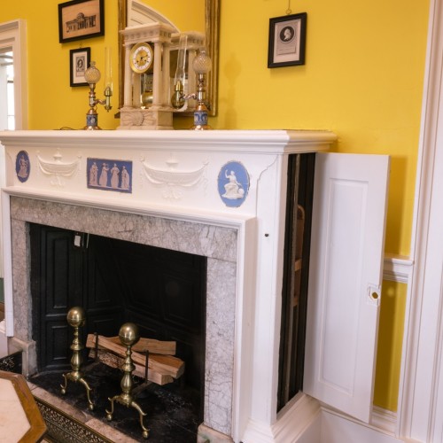 Image of the Dining Room fireplace with a 'wine dumbwaiter' to the wine cellar along the side