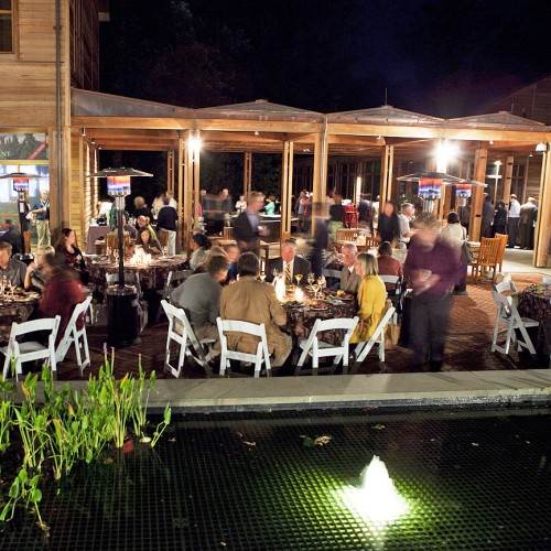 Guests at an evening event in the courtyard of the David M. Rubenstein Visitor Center and Carl and Hunter Smith Education Center