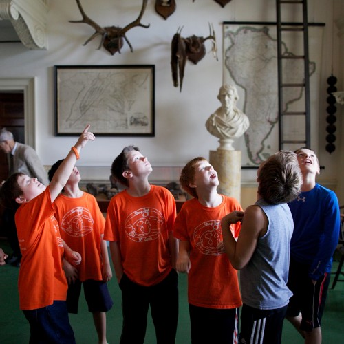 Elementary school students look excitedly at artifacts and architecture in Monticello's Entrance Hall