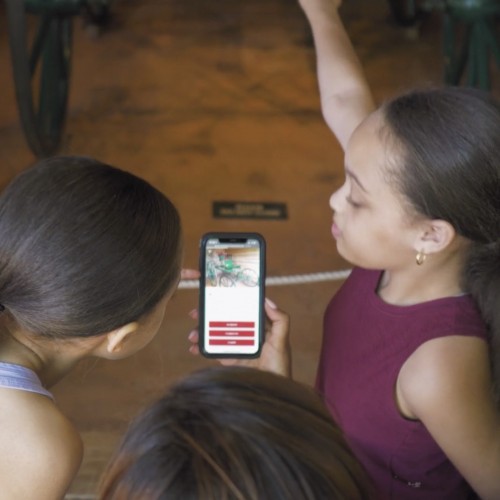 A mother and daugher using the scavenger hunt on a mobile phone at Monticello