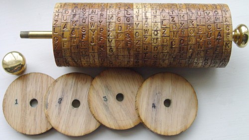 The partially disassembled model with four disks removed and laying sideways showing how the cipher key could be changed to heighten the strength of the encoding system.