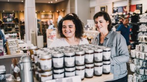 A woman and girl looking at jellies on a display in Monticello's gift shop