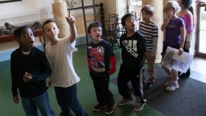 Upper elementary school students react with faces of surprise to seeing artifacts in Monticello's Entrance Hall.